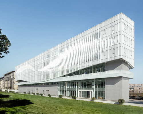 feather-shaped reliefs adorn this mixed-use building façade in eastern china