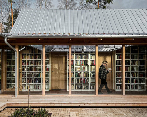 emerging from a swedish forest, fria folket's house is organized around an extensive library