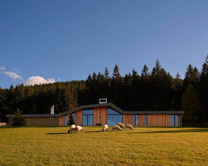 angled roof formation shields wooden residence in czech mountains