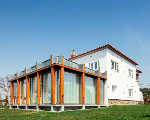 glazed lounge extension breathes new life into vacant building in portugal