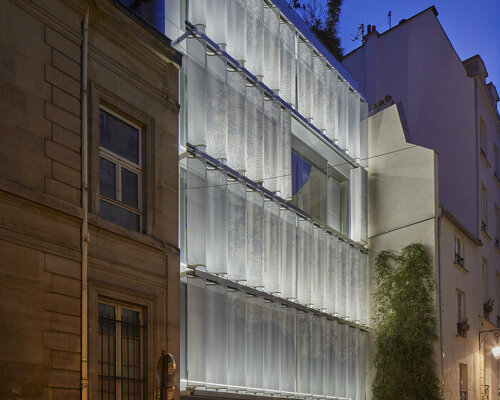 inside outside shrouds new parisian building with a perforated textile façade