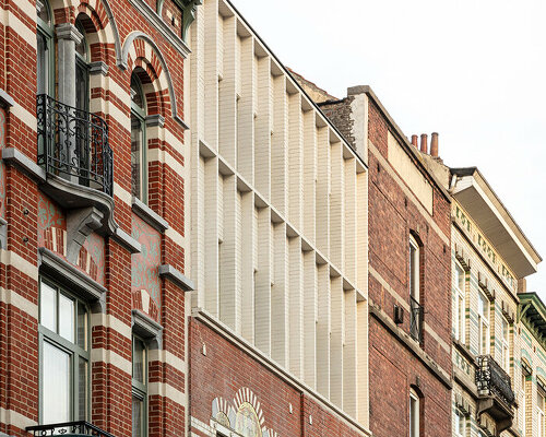 hé! transforms industrial building into house with timber roof extension in brussels