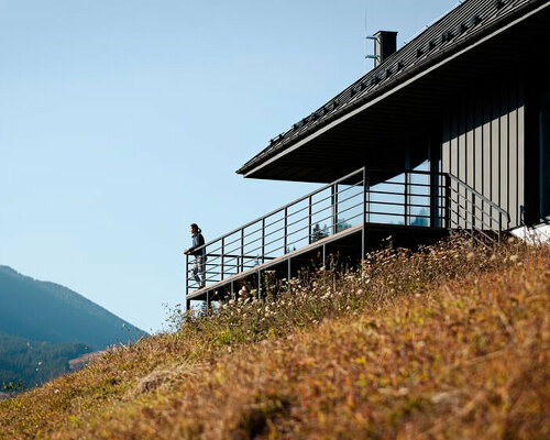 traditional wood-sewn roof tops cottage in ukraine overlooking the carpathian mountains