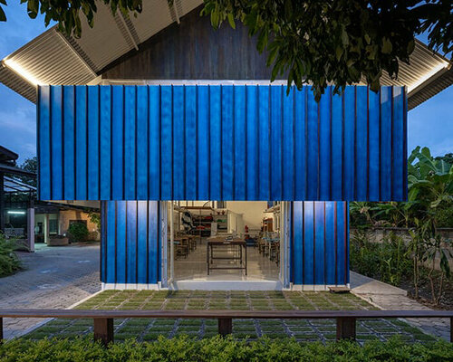 sher maker tops pleated wood longhouse with steel roof for fashion studio in chiang mai