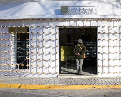 EFEEME arquitectos uplifts bakery façade in argentina with smooth iron and wooden props