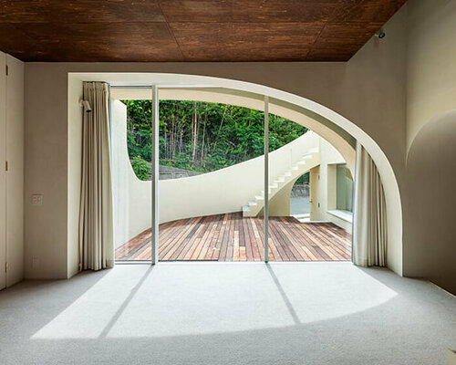 'spline' house's smooth curves frame forest backdrop in osaka