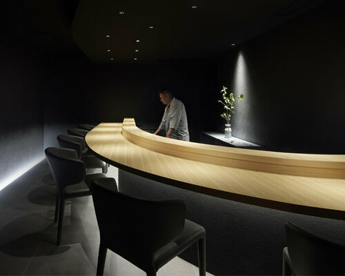 black-ink walls and dimmed lighting engulf this members-only sushi restaurant in tokyo