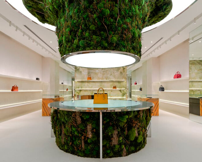 abstract tree installation sprouts from the floor to display premium leather goods