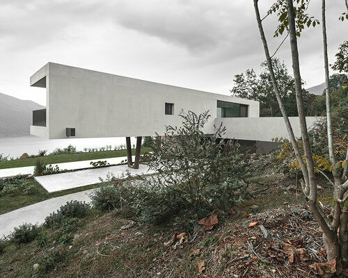 cantilevered concrete house by bergmeisterwolf emerges as a monolith carved into the rock