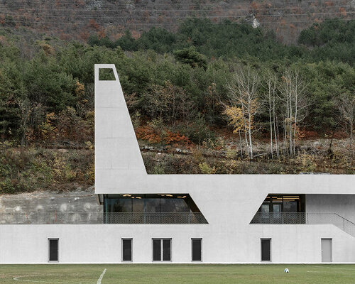 modusarchitects' long concrete sports center divides italian mountain