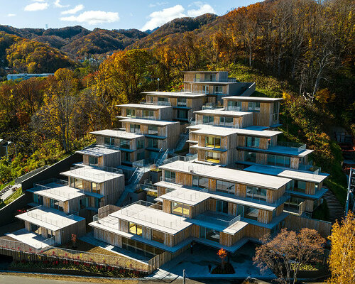 kengo kuma's staggered house units climb a mountainside in japan