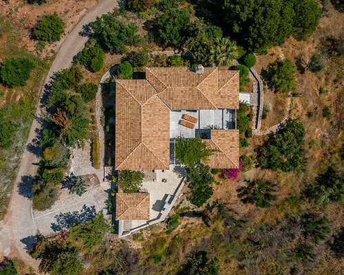 mediterranean summer hacienda unwraps on an olive grove hill in greece