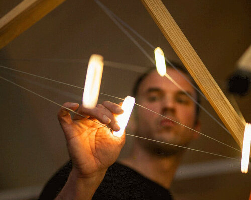 sculptural tensegrity lamp strikes a luminous balance between compression and tension