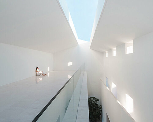 fran silvestre arquitectos enlivens 20th-century house in spain with triple-height interiors