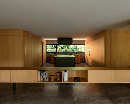 oak wood skin curves the edges of loma apartment in mexico