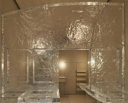 anne holtrop nestles jewelry series within monolithic translucent wall in parisian boutique