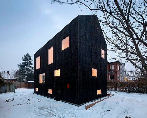 burnt timber composes barn-shaped villa by nord architects in copenhagen