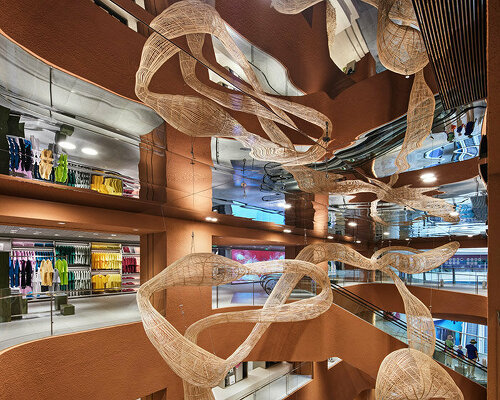 woven bamboo installation by AIM architecture drapes over fashion store atrium in china