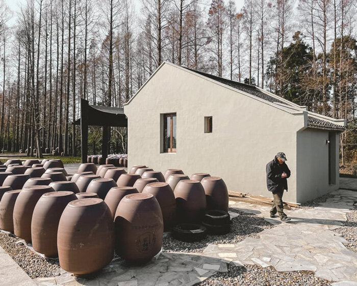 far workshop revives chinese lodge as wine cellar marked by black concrete columns