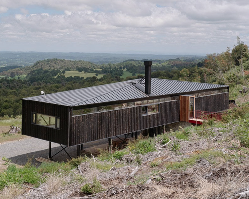 elongated 'la empastada house' frames sweeping vistas of rural chile