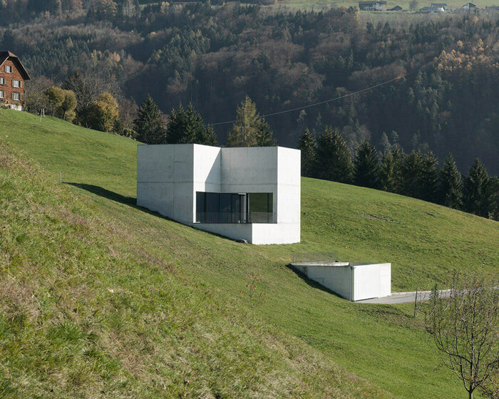 marte marte architects embeds monolithic 'house of chambers' into an austrian meadow