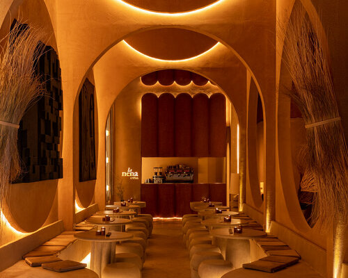 natural textures and earth tones wrap each surface of cavernous la nena cafe in dubai