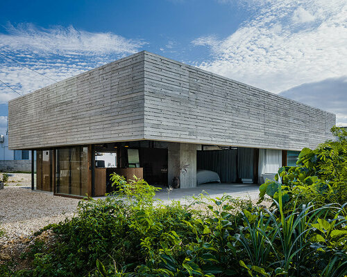 house in japan extends around a single column like an open umbrella