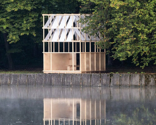 bordering a lake, grau architects' wooden pavilion in czechia nods to japanese tea houses