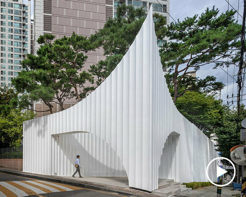 corrugated white wing pavilion forms apartment block entrance gate in south korea