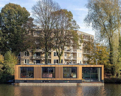 floating wooden houseboat by EVA architecten embraces canal views in utrecht