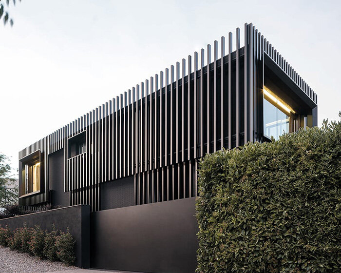 monochrome envelop of black and vertical steel slats modernize family home in barcelona