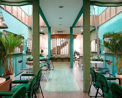 coco cha café develops around light-filled atrium of glass blocks in vietnam