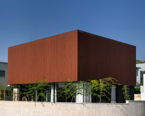 wooden cladded skin wraps floating box house by israelevitz architects in israel