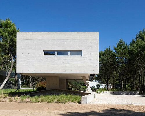 estudio galera rests monolithic home on concrete stilts to maximize space in argentina