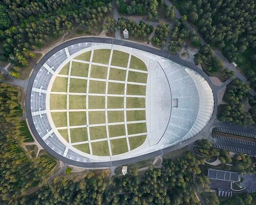 mežaparks open-air stage in latvia is 'a silver grove among a natural forest'