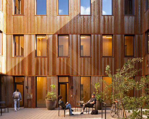 all-wood mass timber building in portland, oregon is wrapped in a steel 'rain jacket'