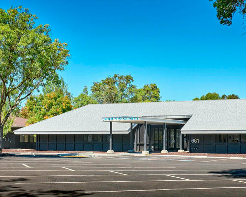 university research facility expands under floating asymmetrical pitched roof in california