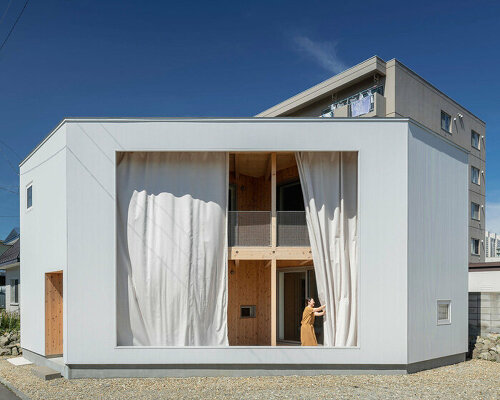 large curtain wall transforms japanese home's intimate interior into semi-external verandah