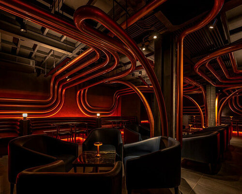 bangkok bar disguised as pawnshop indulges visitors in ambient lighting and sculptural loops