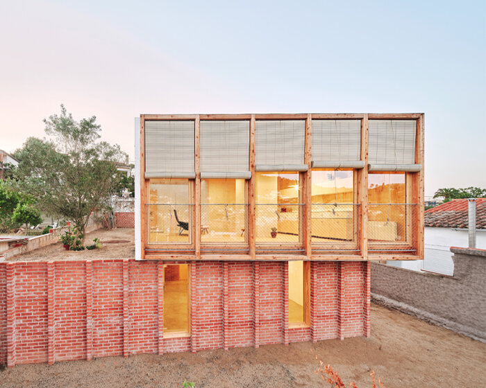 ágora arquitectura stacks cross laminated timber house atop old brick base in spain