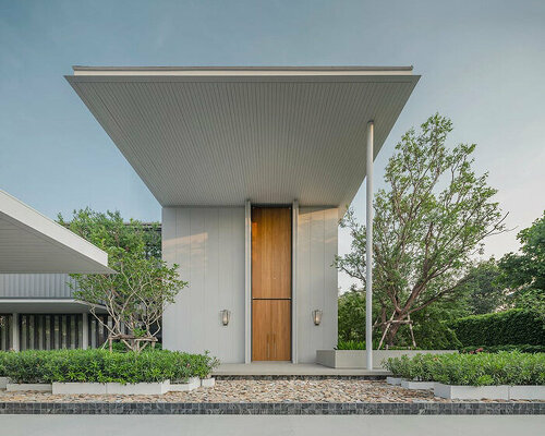 volumes, voids, and a warm ambience shape anonym studio's feng shui home in bangkok