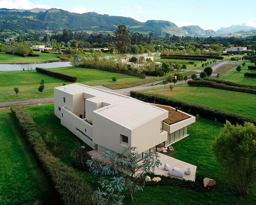 'casa la reserva' emerges as a carved monolith in the mountainous colombian landscape