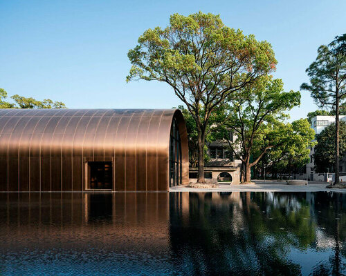 wutopia lab encloses cultural activities within arched copper blockhouse in shanghai