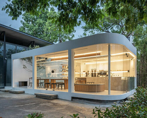 transparent walls and floating glass corners offer cafe-goers a quiet respite in bangkok