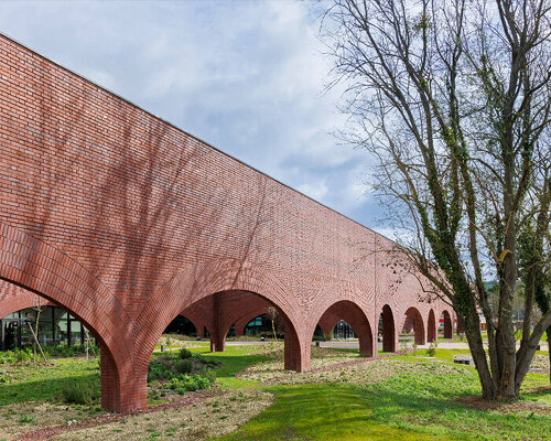 lina ghotmeh brings sweeping arches to brick-clad hermès workshop in normandy