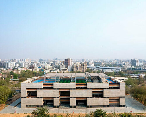 playfully stacked geometric concrete volumes compose student facility in india