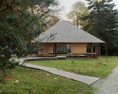 charly jolliet's umbrella-shaped canopy in switzerland spotlights traditional wood cladding