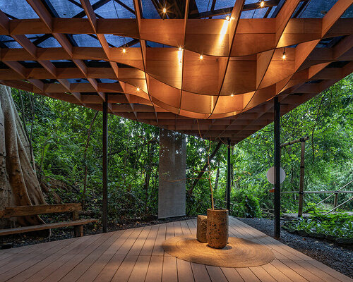 DDAP architect's undulating jia pavilion encloses warm interiors amidst bali jungle