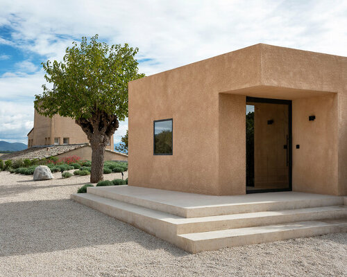 sand-colored concrete 'câlin' residence nestles on a sloping secluded site in france