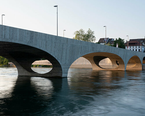 christ & gantenbein complements swiss riverside with gently arched concrete bridge